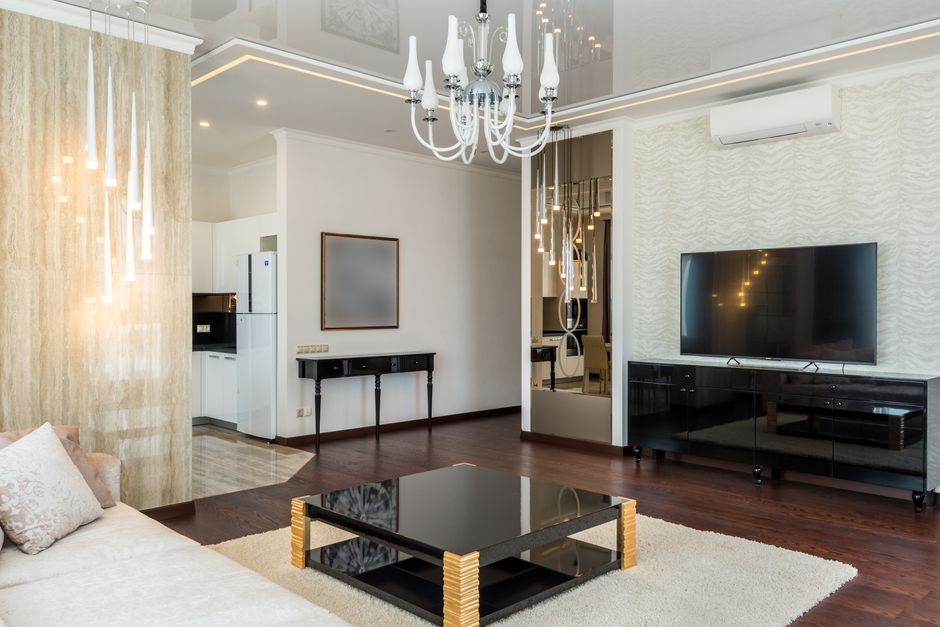Een modern zwart tv meubel in een stijlvolle woonkamer met minimalistisch design en warme verlichting.